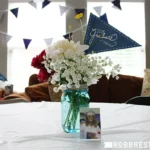Graduation-themed flower centerpiece on table