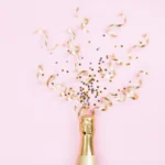 Champagne bottle with gold confetti