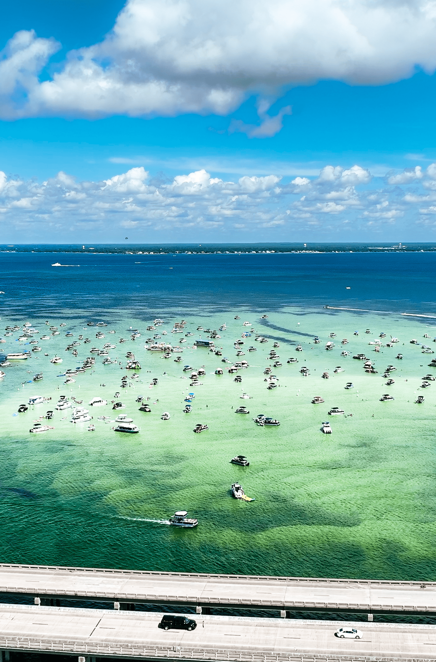 Boats on turquoise ocean under blue sky
