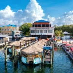 Waterfront restaurant with tiki huts and boats