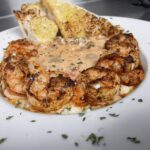 Grilled shrimp arranged over creamy sauce