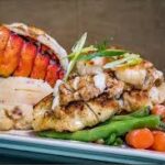 Grilled seafood platter with lobster and vegetables